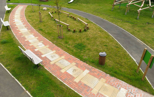 Public art installation - several metal plaques set in stone pathway