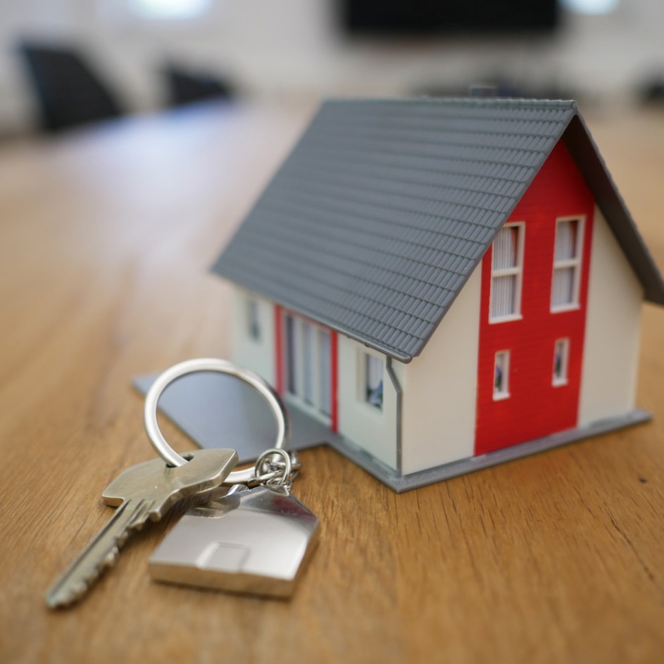 Close-up of a keys on table, with a small metal house charm on the keyring