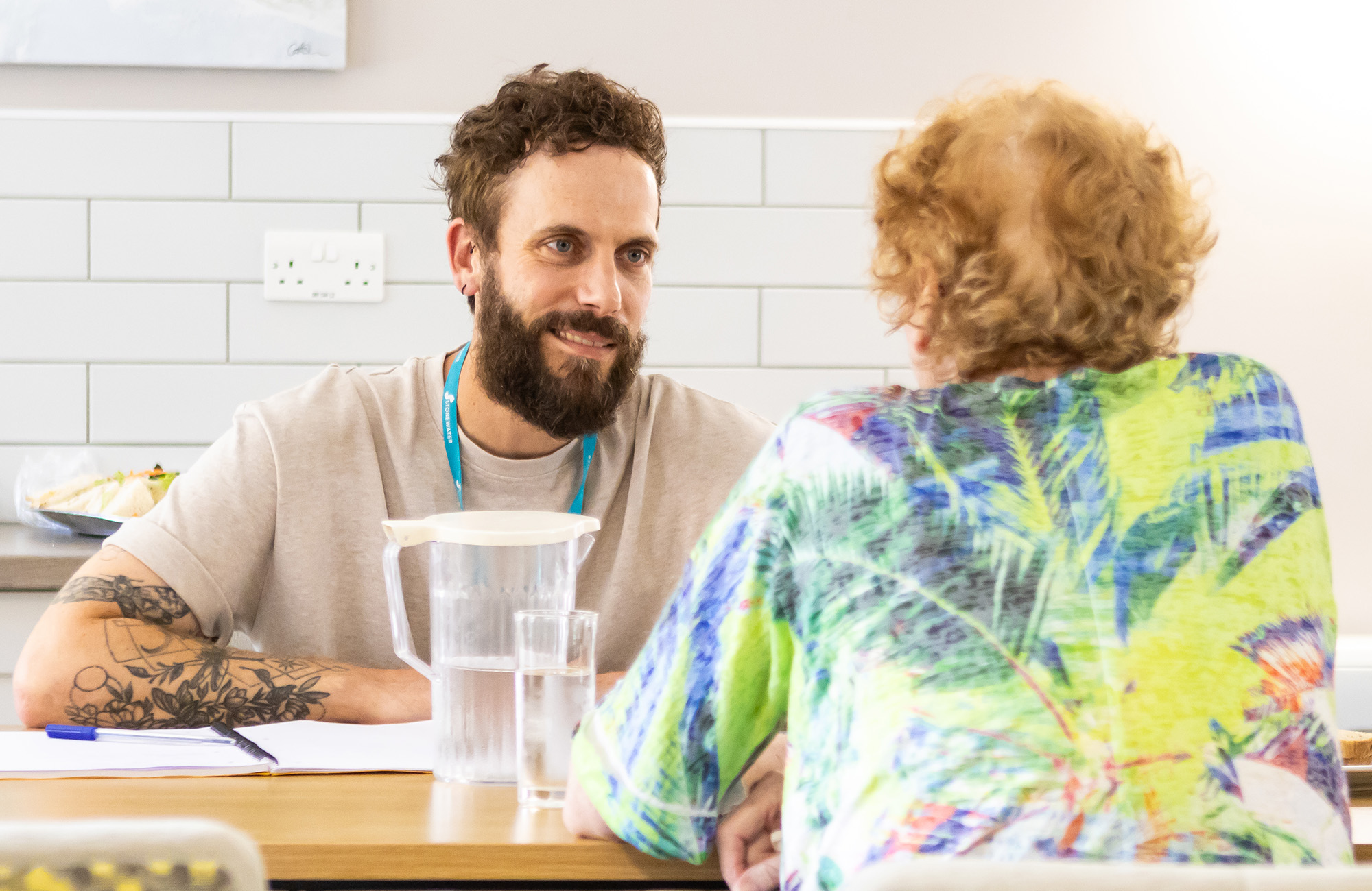 Two people sat at a table having a conversation