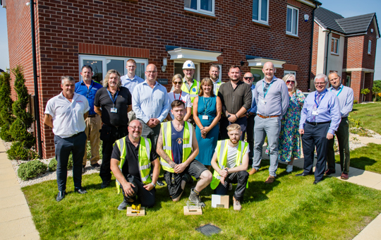 Group outside new-build home at Drummond Park